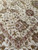 Detail of sage vinework, gray blossoms and soft pink inner border on the ivory ground