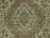 Close-up of sage green lobed medallion with arabesque leaves, rose palmettes and blue accents