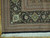 Corner detail showing black palmette border, cream rosettes, green vine work and ivory cotton fringe