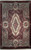 Full view of ivory and burgundy Savonnerie rug with pink rose medallion and acanthus scrollwork