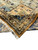 Fringed corner with sage field, camel border and a glimpse of the woven reverse side