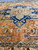 12'4" x 16'2" Heriz Serapi rug photographed at floor level showing medallion pendant and open field