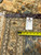 Inventory tag marked 12.4 x 16.2 with a tape measure resting on the woven back