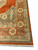 Border corner of the rug with rosette discs, vine scroll and sage guard stripes