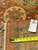 11'8" x 12'4" rug back with tape measure and tag documenting size and knot density