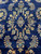 Detail of golden floral sprays, paisley boteh and turquoise blossoms scattered across the indigo navy field
