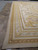 Side view of 13'8" x 23'1" mansion size rug showing straight edges and wide borders