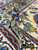 Macro detail of sage border and ivory field florals in dense hand-knotted lamb wool