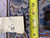 Reverse side with measuring tape and inventory tag confirming 12'3" x 17'2" oversize dimensions