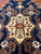 Ivory 8 point star medallion filled with red and green flowers on navy Heriz ground