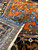 Back of the 14'2" x 19'2" Persian Heriz rug showing tight knotting beside coral border
