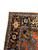 Navy main border with turtle palmettes, green leaves and ivory rosettes at the rug corner