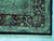 Corner detail of sage and burgundy guard borders finished with clean ivory hand-knotted fringe