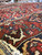 Large 11x16 Bakhtiar rug in low angle close view revealing pile depth and indigo border rosettes