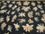 Close up of hand stitched rose, peony and chrysanthemum sprays in peach, cream and green wool