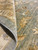 Folded corner reveals dense hand-knotted wool pile and grey cotton foundation on Chobi rug