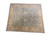 Angled studio shot showing near-square oversize hand-knotted wool rug in soft sage and cream tones