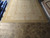 Chinese hand woven Aubusson rug seen from one end, ivory field framed in wheat gold