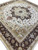 Made in India 14 x 14 square rug photographed at angle showing medallion, spandrels and borders