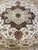 Half view of star medallion, ivory field and rust corner pendant on large square rug