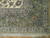 Corner detail showing ivory field meeting sage green border with navy outlined palmettes and rust blossoms