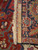 Back of the wool rug with ruler, showing knot density, cotton foundation and original fringe