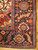 Corner detail of indigo border with rosette palmettes, sky blue guard stripes and ivory fringe