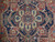 Close-up of ivory and navy stepped medallion with blue leaf motifs and rose rosette center