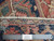 Back of the 6'10" x 10' Heriz rug with ruler proving hand-knotted wool weave and knot density