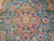Macro shot of the pink medallion center with gold leaves against deep teal ground