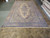 Palace size 10'10" x 18'8" Persian Kerman rug shown full length on warehouse floor