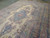 Diagonal floor view highlighting the blue medallion, celadon corners and multi-colored floral border