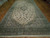 Oversize 10x20 Persian rug viewed from the opposite end, sage borders framing dense floral vinework