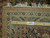 Back of the rug with ruler showing fine hand knotted weave and authentic hand woven label