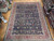 Oversize 11x14 navy Mahal rug seen at an angle showing rose red border and ivory guard stripes