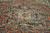 Close-up of the stepped geometric medallion with palmettes in rust, indigo blue and soft yellow