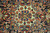 Ivory medallion core detail showing hand-knotted wool pile, blue rosettes and coral lobed cartouches