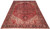 10'8" x 14'4" Persian Heriz rug shown at an angle with deep red field and navy border