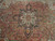 Close-up of the 8 pointed star medallion with olive, ivory and blue detail on rust