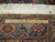 Reverse of the rug with ruler on the weave, cotton foundation and clean ivory fringe