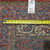 Tape measure and dealer tag confirming the 6'11" width on this hand woven Oriental rug