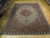 9x12 antique Persian Kashan rug displayed full length with ivory medallion field and navy borders