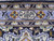 Woven signature cartouche set in the periwinkle border of this signed Persian Kashan wool rug