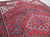 10'1 x 14 Persian Heriz rug at an angle, wool pile texture and geometric medallion