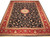 Navy blue and red Tabriz design rug shown flat with ivory floral medallion and wide border