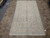 Angled view of handmade wool Kashan rug, cream field with powder blue vines and rosettes