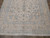 Close view of scrolling border and floral field in soft peach and pale blue tones