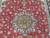 Seafoam green and navy floral medallion at the center of this fine Persian Tabriz rug
