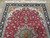Upper field and ivory spandrels of the Tabriz rug photographed from above indoors
