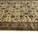 End view of the ivory field showing repeating rosettes, palmettes and the camel outer border band